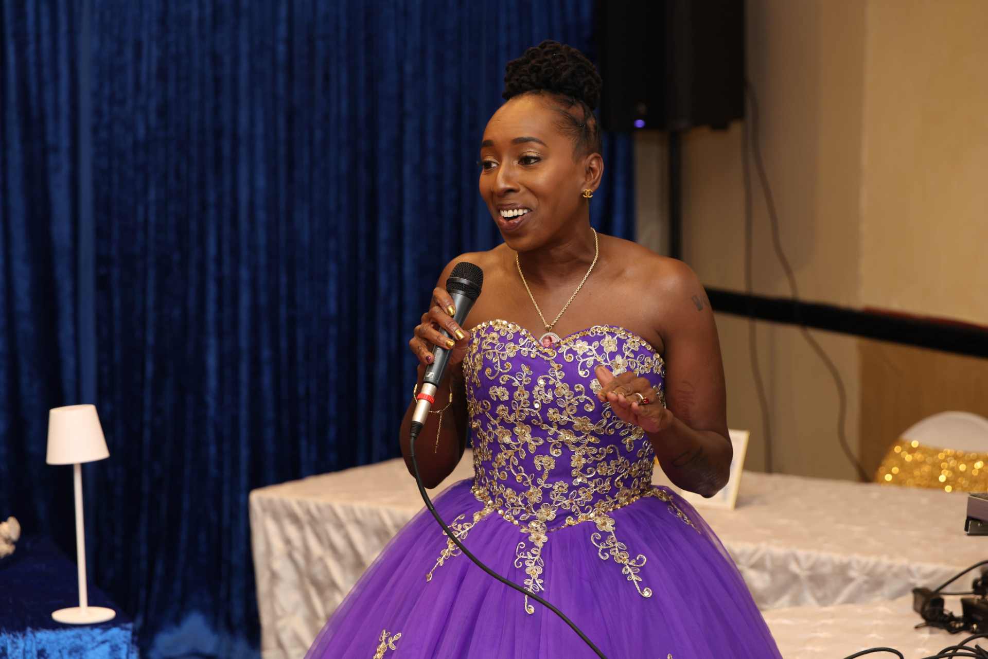 2025 gala speaker in purple ball gown at Winnin Against Addiction event