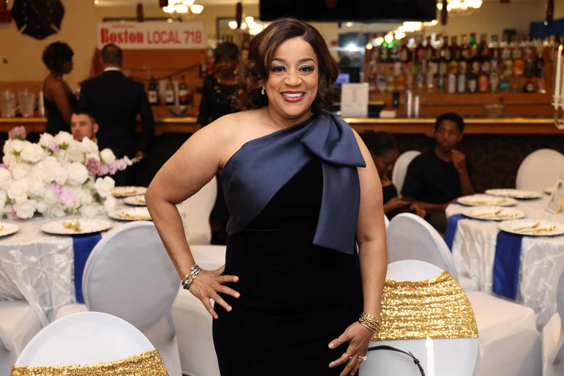 2025 Winnin Against Addiction gala attendee in elegant black dress with navy bow